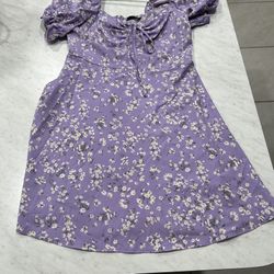 Purple dress with floral pattern and puff sleeves.