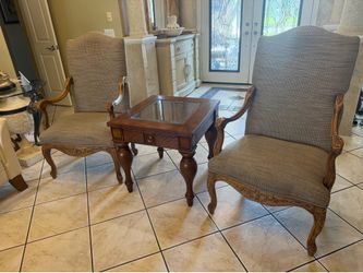 set of chairs and end table that are in excellent condition with carved wood frame and upgraded fabric with staying protectant