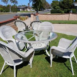 Wicker table, chairs, chaise lounges
