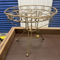 vintage Hollywood Regency style plant stand, crafted from gold-painted wrought iron featuring a rope twist design