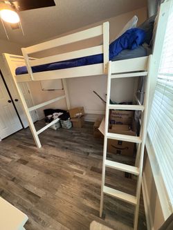 White wooden loft bed with instructions and hardware