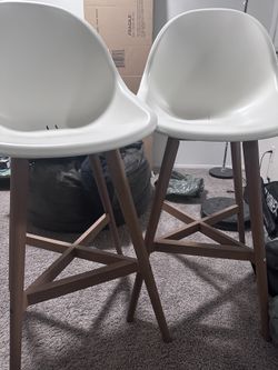 2 white bar stools with wooden legs