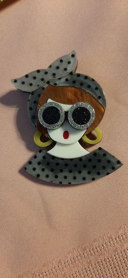 Cute brooch of a girl with sunglasses.