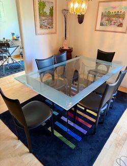 Dining room table glass with leather chairs