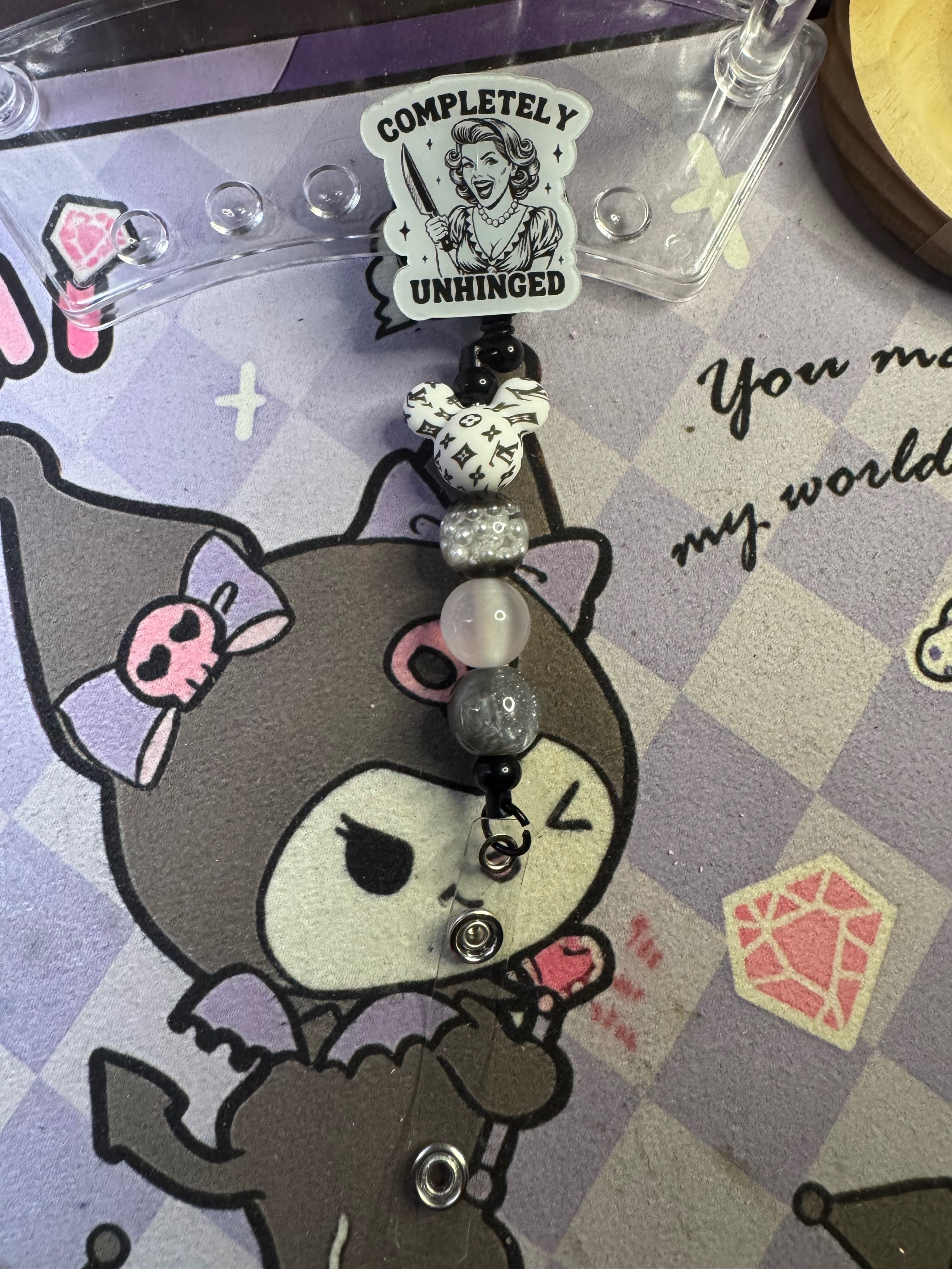 "Completely Unhinged" acrylic focal saying on a badge reel