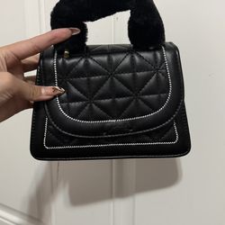 Black quilted purse with fur handle