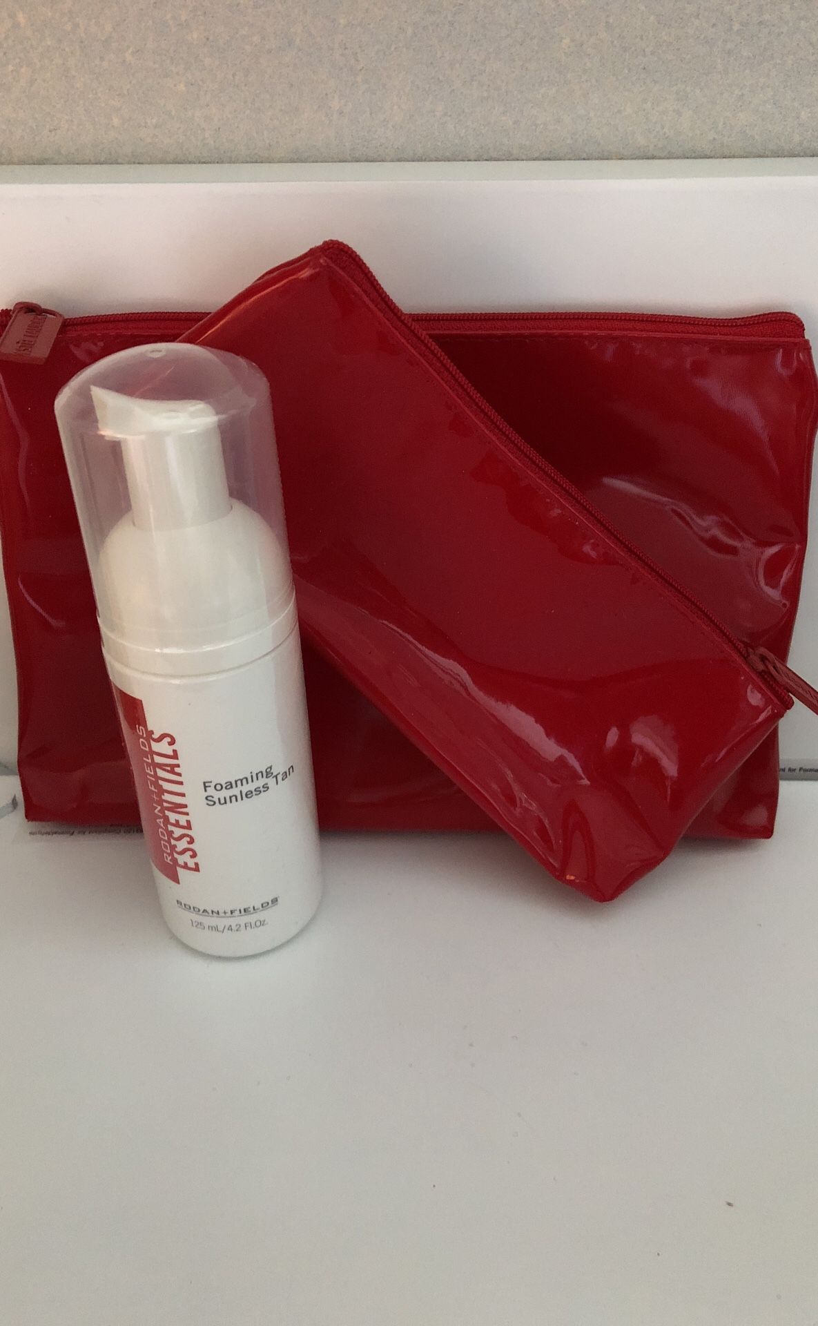 Rodan + Fields Foaming Sunless Tan; Gift-red make up bag