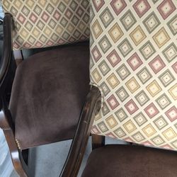 Suede and wooden chairs. 