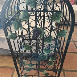 Black metal wine rack grape leaf design