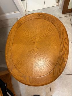 Solid oak round coffee table with a lower storage shelf.