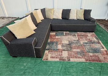 Sectional fabric sofa with contrasting white pipe details and neutral decorative cushions can be delivered for an additional cost Presio 250