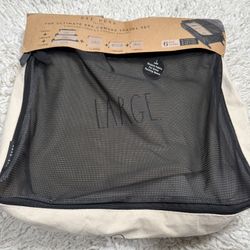 Rae Dunn Travri The Ultimate 6pc Canvas Travel Set, which includes three packing cubes and three zippered pouches. The set comes in small, medium, and