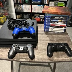 PlayStation 4 Pro (PS4) with two controllers 12 games (w/ 2 steelbooks and book)