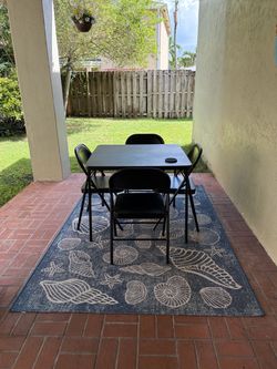 Patio table, chairs, cushions with rug