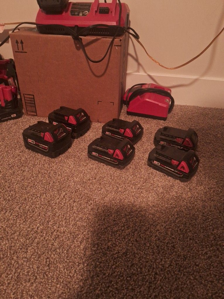 Various Milwaukee M18 Batteries And Chargers