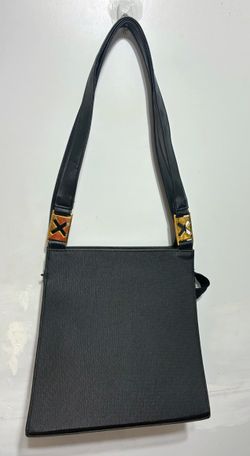 Unusual black rectangle purse hard with gold cut out x’s has sheen 