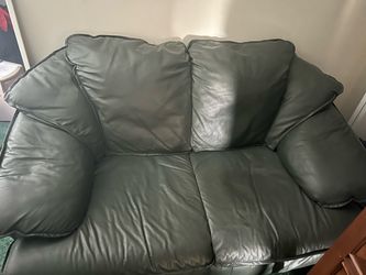 Green leather sofa with matching love seat