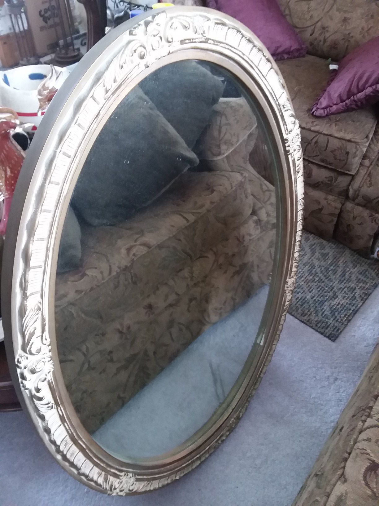 Antique mirror, oval and it is Heavy.