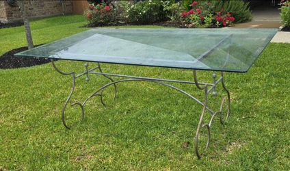 Glass top outdoor table on metal base