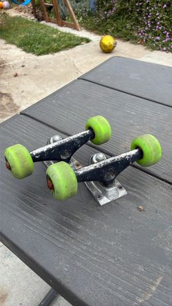 Krux Skateboard Trucks with Green Wheels
