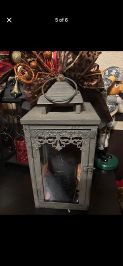 Grey metal lantern with decor