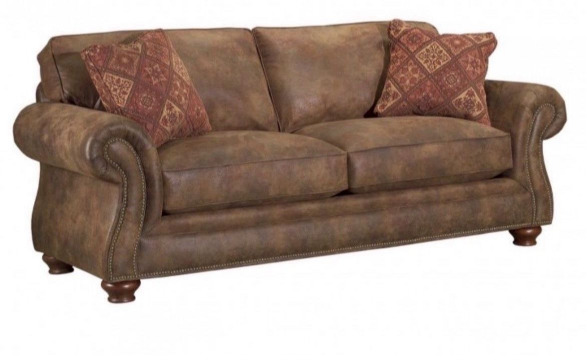 Large brown cushioned sofa couch with pillows