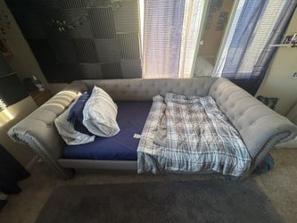 Bed with another bed underneath like a bunk bed