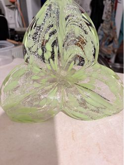 Murano art glass flower sculpture with a green and white swirling design and a spiral stem.