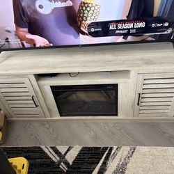 Wood entertainment center with LED fireplace and shelves