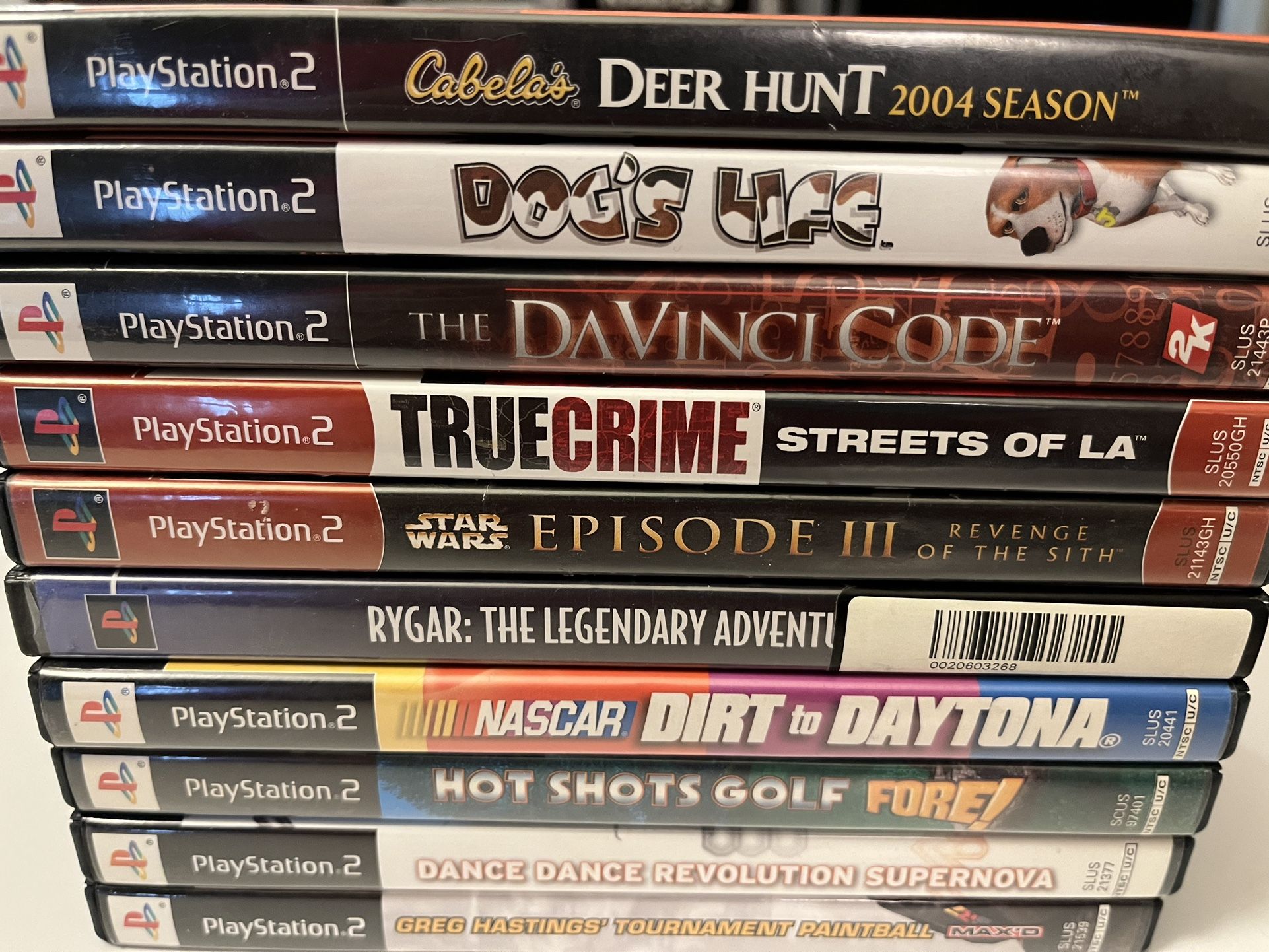 10- PS2 game lot. DDR-Hot Shots Golf- Paintball- Davinci Code-Dogs Life-Nascar.