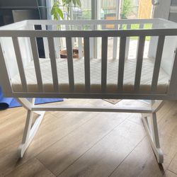 White wooden rocking bassinet