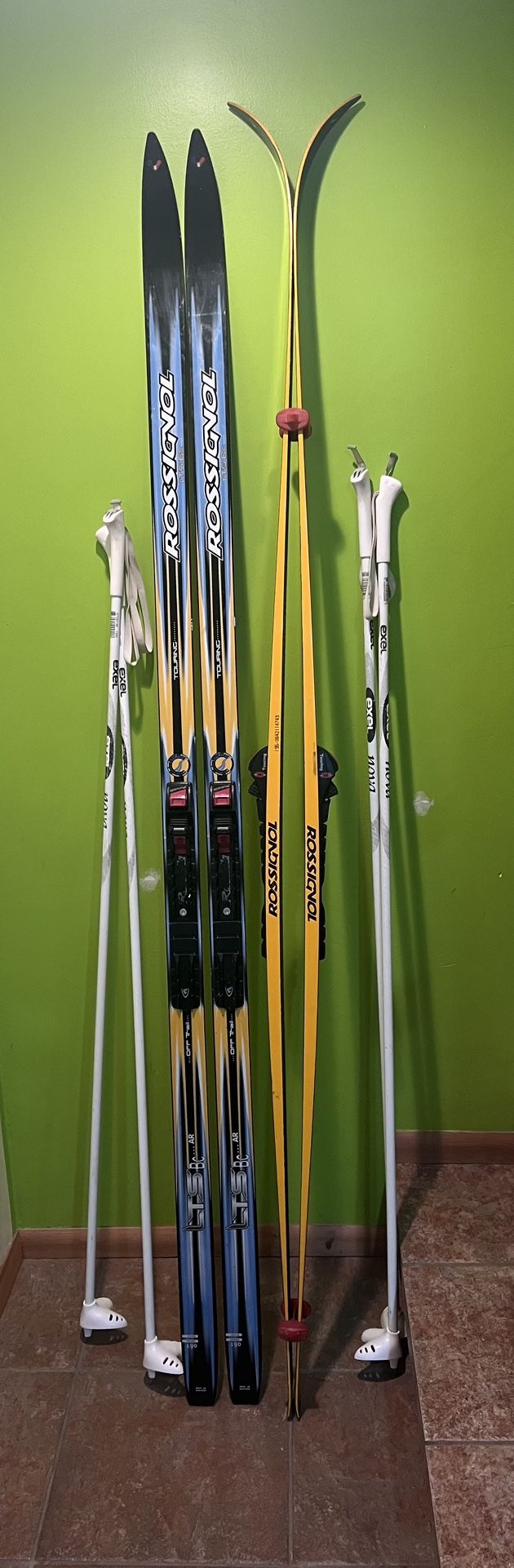 Two pairs of Cross country Rossignol Touring skis with automatic NNN bindings and poles