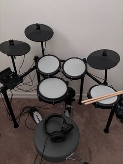 Electric drum kit, headphones, and throne