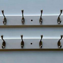 Wall-mounted coat rack featuring multiple metal hooks