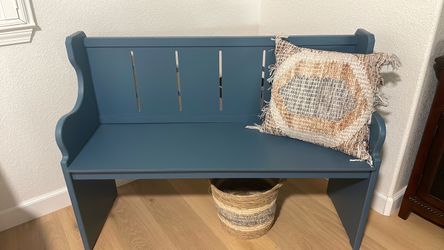 Blue bench with basket and pillow