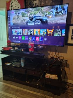 Samsung 65" smart TV with Samsung sound bar and stand that goes up and down with drawers