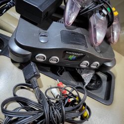 Nintendo 64 system with atomic purple Controller, av cord, and power cord 
Working perfectly. 