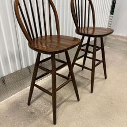 Two solid wood vintage bar stools , both swivel..,