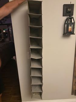 multi-shelf fabric hanging closet and shoe organizer in grey.