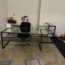 L shape glass desk and  comfy rolling chair
