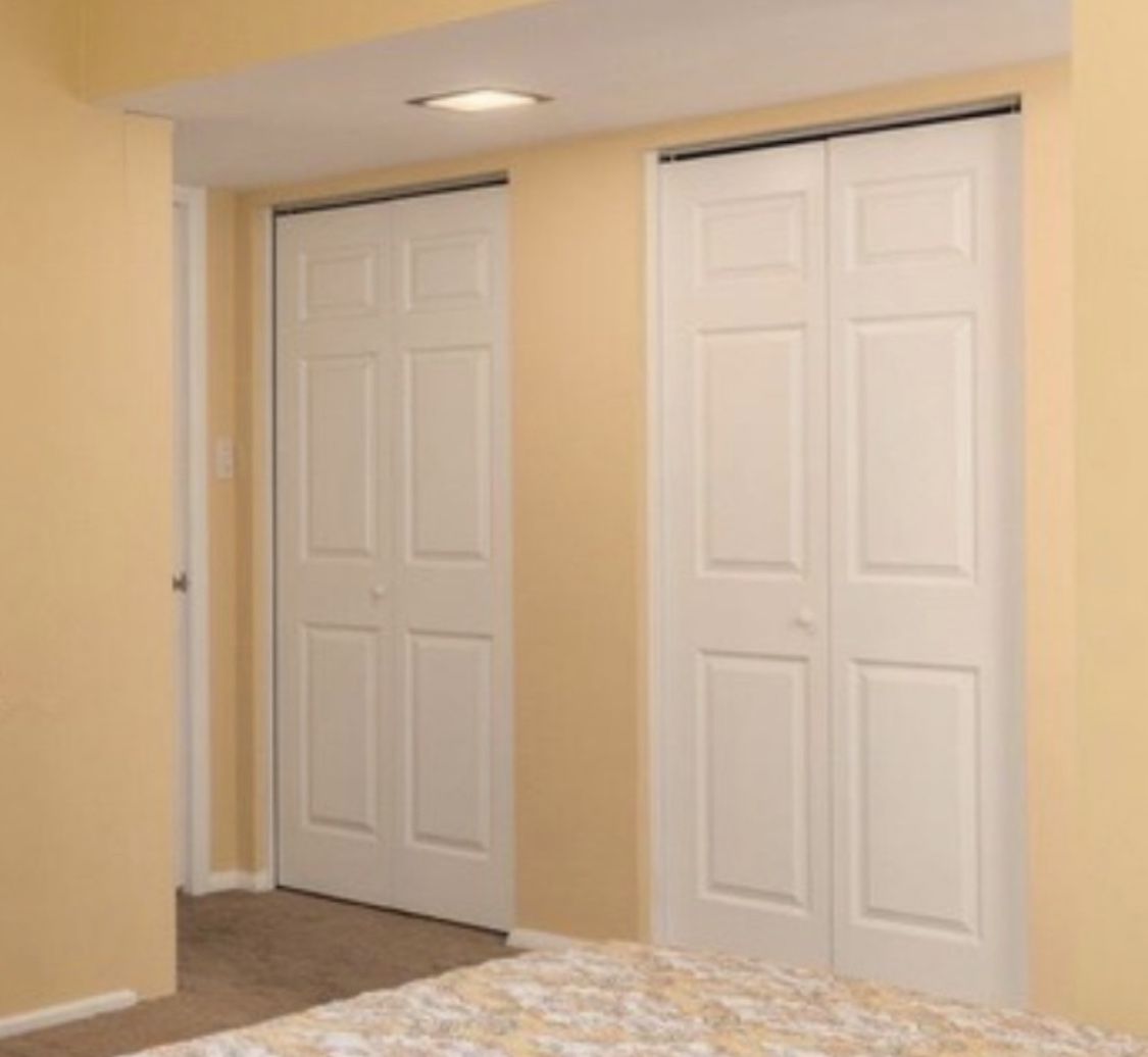 Two white folding closet doors bi fold