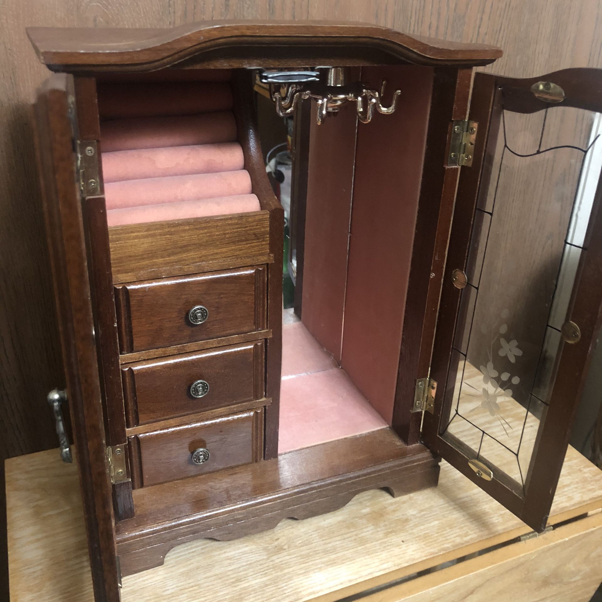 Vintage jewelry armoire with a music box