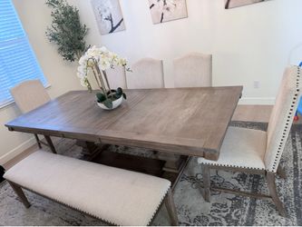Extendable dining room table with chairs and bench