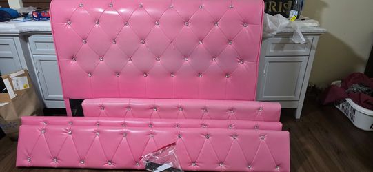 Pink Tufted Faux pink Leather Bed Headboard Set full-size pink bed with two speakers.