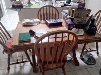 Heavy duty wood kitchen table with 4 solid chairs.