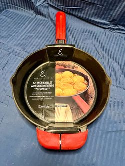 Emeril Lagasse 12-inch pre-seasoned cast iron Deep skillet with removable red silicone grips.