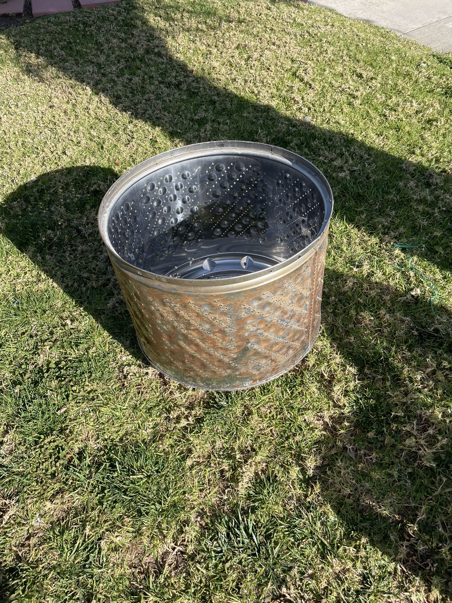 A metal fire pit made from a repurposed washer machine is a unique and eco-friendly addition to any outdoor space. This fire pit has been crafted from