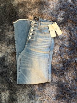 7 For All Mankind jeans feature a high-rise button fly and a frayed hem