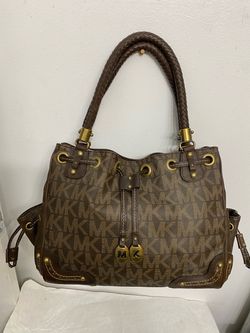 Michael Kors drawstring shoulder bag featuring a signature MK print and braided leather handles. Brand new without tags