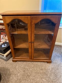 Small wooden china cabinet with glass doors